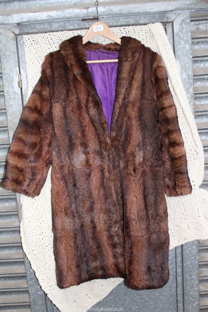 A ladies three quarter length fur Coat having purple lining, size small.