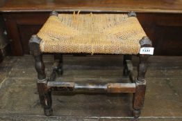 A woven seagrass seated Stool standing on turned supports with perimeter stretchers,