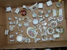 A large quantity of china miniatures to include; plates, chairs, cups & saucers, piano, etc.