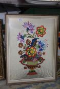 A framed original embroidery of a flower arrangement.
