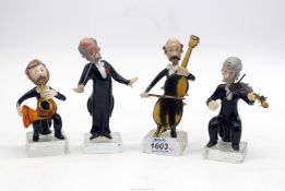A set of four glass musicians including cello, violin and horn player and the conductor.