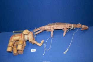 A wooden crocodile puppet and a wooden elephant puppet.