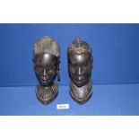 Two carved African heads of a lady and a man, 8'' tall.