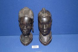 Two carved African heads of a lady and a man, 8'' tall.