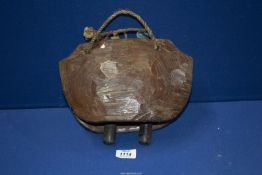 A large antique wooden cow Bell, 11" wide.