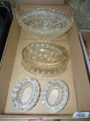 An oval pressed glass bowl, two glass salt cellars and glass jelly mould.