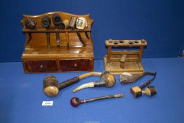Two pipe racks, one having burl wood faced drawers, plus eleven mainly novelty smoking pipes.