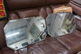 Two bevelled edge octagonal wall mirrors, 24" and 26" wide.