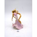 An Art Deco style figure of a Dancing lady in pink dress, 8" tall.