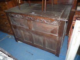 An unusual peg-joyned five panel fronted Blanket Chest having a carved upper rail decorated with