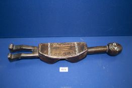 A Tribal art Bamum headrest figure with incised decoration, 20" long.