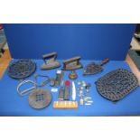 A quantity of metals including cast iron trivets, flat irons, bell, buttons, cut throat razors, etc.