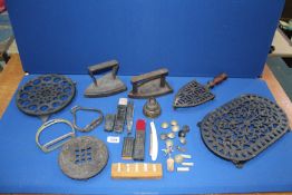 A quantity of metals including cast iron trivets, flat irons, bell, buttons, cut throat razors, etc.