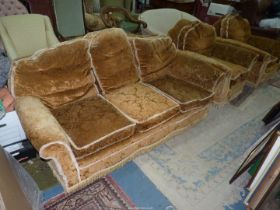 A rust/mustard coloured upholstered pre-1950 Lounge Suite comprising a three seater settee and a