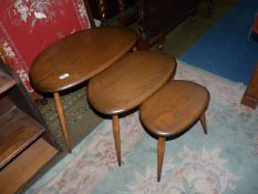 A nest of three Ercol Elm pebble shaped topped Occasional Tables,