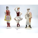 A Hollohaza porcelain figures of a lady in traditional dress a Budapest figure and a dancer also