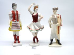 A Hollohaza porcelain figures of a lady in traditional dress a Budapest figure and a dancer also