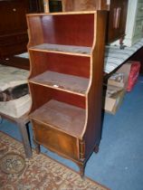 An unusual Mahogany Waterfall three tier Bookshelves having a cupboard below and decorated with