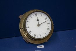 A Metamec Quartz porthole wall clock with brass effect plastic frame.