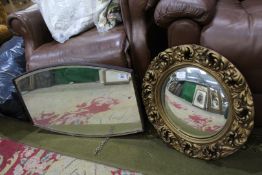 An ornate framed circular convex wall mirror,