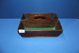 A darkwood cutlery box with green baize lining.