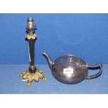 A Pewter teapot with hinged lid and beaten finish and a small brass table lamp with black reeded
