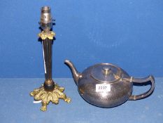 A Pewter teapot with hinged lid and beaten finish and a small brass table lamp with black reeded