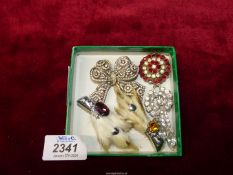 A small box of brooches to include Celtic animal paws, etc.