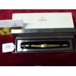 A 750 gold Omega lady's Cocktail wrist watch having baton hour markers, original box,