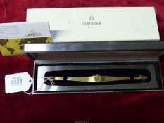 A 750 gold Omega lady's Cocktail wrist watch having baton hour markers, original box,
