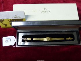 A 750 gold Omega lady's Cocktail wrist watch having baton hour markers, original box,