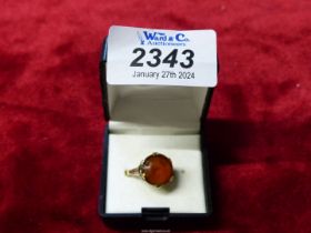 A 9ct gold ladies ring, set with a large orange stone, 3.8g.