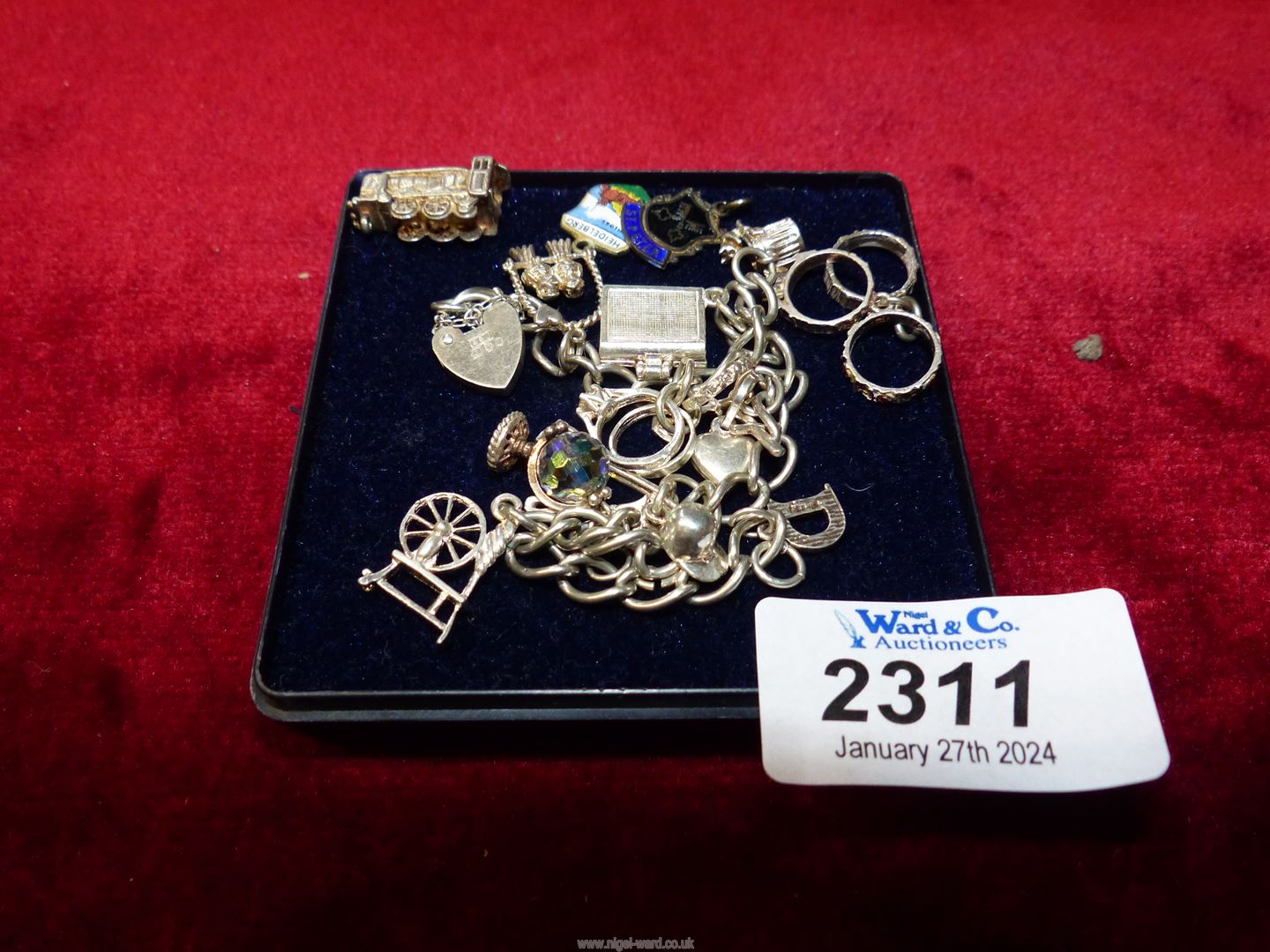 A small Silver charm Bracelet with London hallmark with heart locket clasp (no charms marked) and