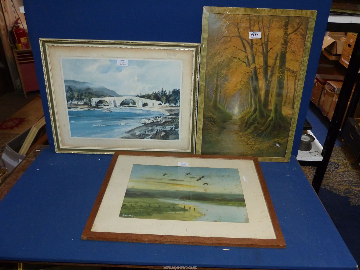 Three Prints to include; a Rowland Hilder river scene, one by Peter Scott and a woodland scene.