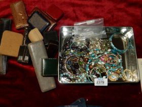 A quantity of costume jewellery including brooches, bangles, stick pin,