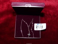 A 9ct white gold crucifix and chain with one chip diamond to centre of crucifix.