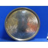 A large brass hand beaten Benares tray with Arabic script and designs, of some age, 23" diameter.