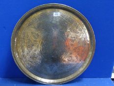 A large brass hand beaten Benares tray with Arabic script and designs, of some age, 23" diameter.