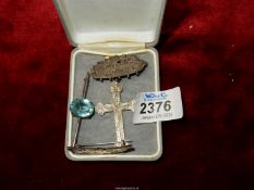 Three silver brooches including bar brooch with pale blue centre,