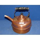 A copper Kettle with wooden handle.