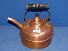 A copper Kettle with wooden handle.