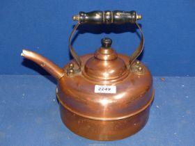 A copper Kettle with wooden handle.