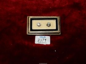 A presentation cased pair of 9ct marked screw-down Studs having octagonal mother of pearl mounts,