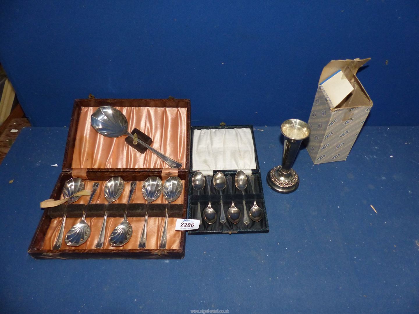 A cased set of six coffee spoons, set of dessert spoons, and posy vase.