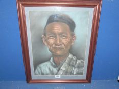 A framed and mounted Charcoal portrait of an Oriental gentleman, no visible signature,