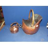 A copper and brass helmet shaped Coal Scuttle and a copper kettle.