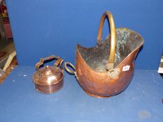 A copper and brass helmet shaped Coal Scuttle and a copper kettle.