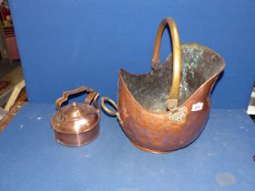 A copper and brass helmet shaped Coal Scuttle and a copper kettle.