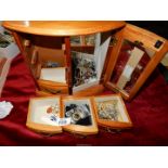 A wooden jewellery box with costume jewellery.