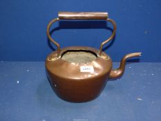 A copper kettle, damaged.